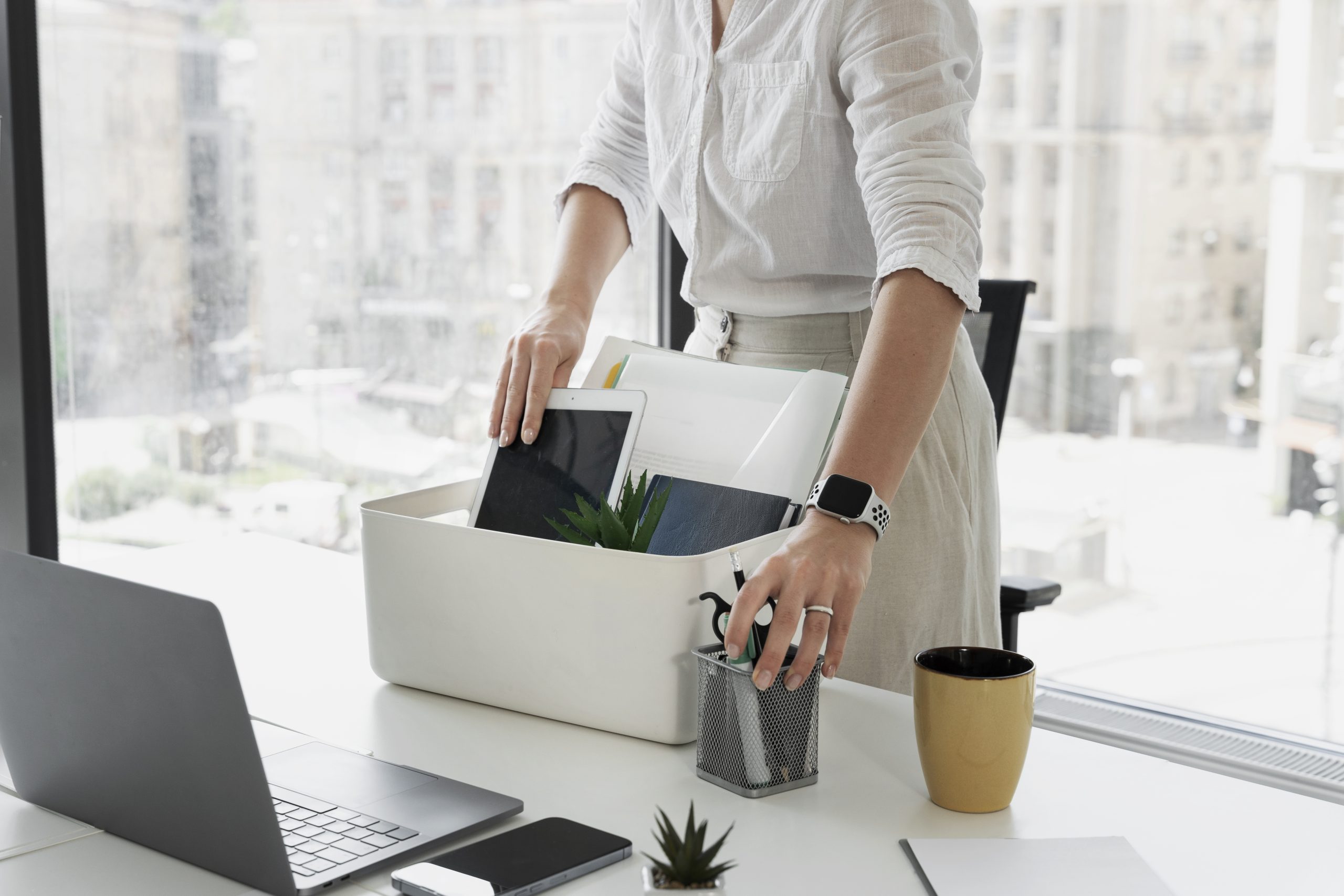 Side view woman packing desk items