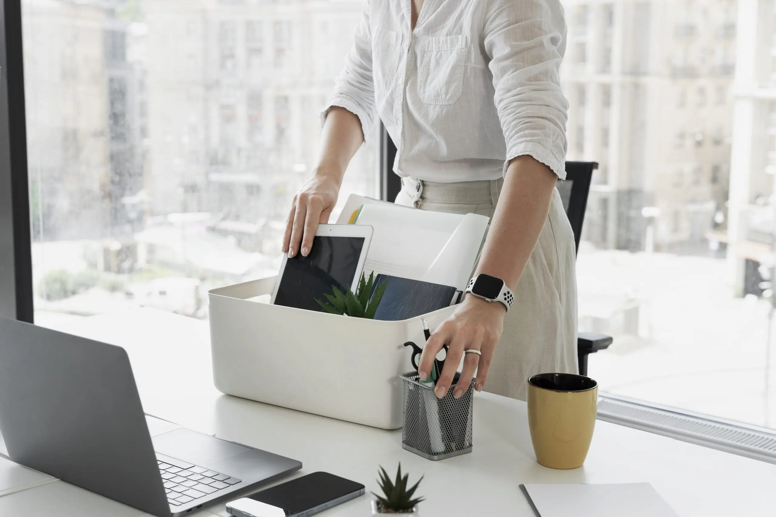 Side view woman packing desk items